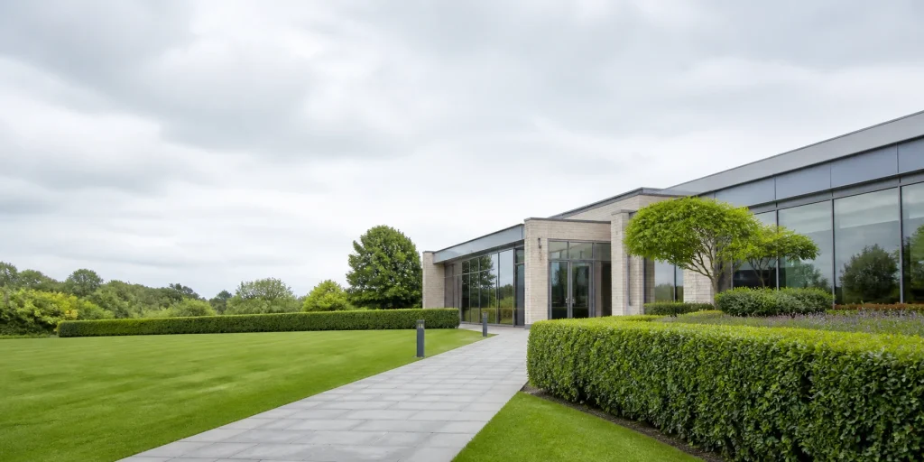 Neatly trimmed hedge beside a commercial garden entrance